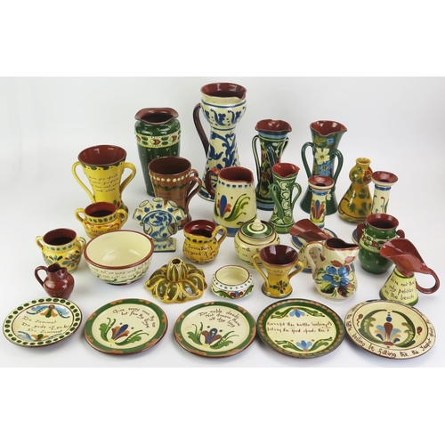 1091 - A collection of Torquay pottery wares, includes candlesticks, vases, jugs, plates and dishes.