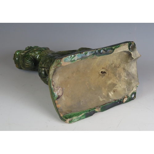 1334 - A Chinese pottery ridge tile surmounted with a recumbent dragon, 26cm high, a/f.