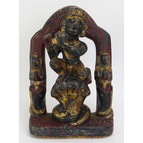 1345 - An Indian carved hardstone and polychrome decorated figure of Krishna with flute and kneeling on Kai... 