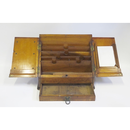 1370 - An Edwardian oak stationery box, with hinged sloping fall, enclosing slatted compartments, with sing... 