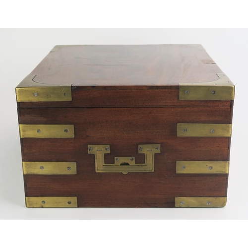 1372 - A mahogany and brass bound campaign box, of rectangular outline, the hinged lid enclosing an associa... 