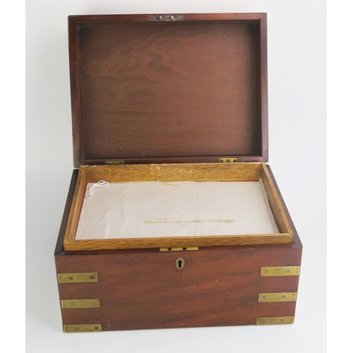 1373 - A mahogany and brass bound campaign box, of rectangular outline, the hinged lid enclosing an associa... 