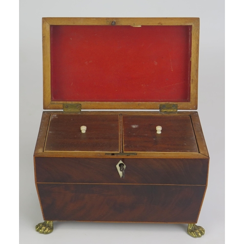 1403 - A Georgian mahogany and boxwood strung tea caddy of sarcophagus outline, the shallow domed hinged li... 