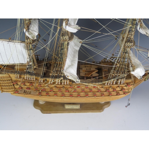 1425 - A wood model of HMS Victory, fully rigged, with cotton stitched sails, on a wood stand, 57cm long.