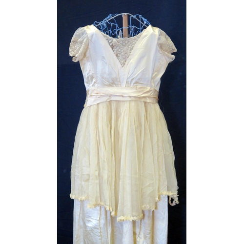 1433 - A 1920's pale apricot silk coming out dress, with applied lace to the V-neck and shoulder straps, wi... 