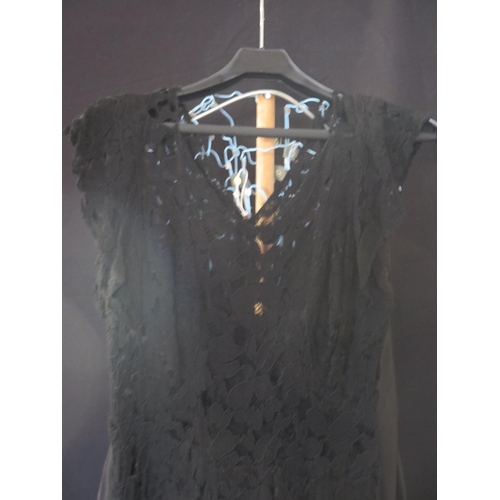 1434 - A 20th century black corded lace cocktail dress of floral design, with plunging V-neck and black app... 