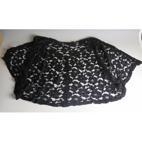 1435 - A 20th century black corded lace cocktail shawl, of floral design.