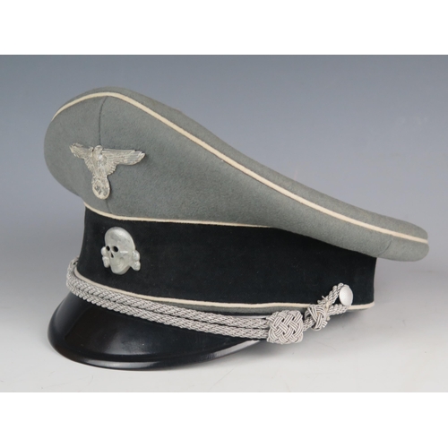 A WW2 German Waffen-SS officer's peaked cap with metal National