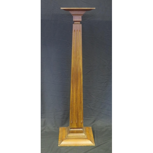 1584 - A mahogany torchere stand with fluted square tapering column on a stepped square base, 137cm high, t... 