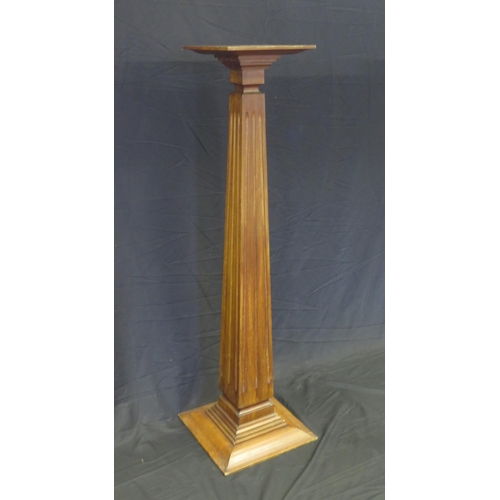 1584 - A mahogany torchere stand with fluted square tapering column on a stepped square base, 137cm high, t... 