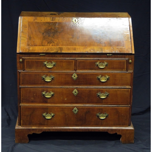 1592 - A George III walnut and feather banded bureau, the sloping hinged fall enclosing an arrangement of d... 