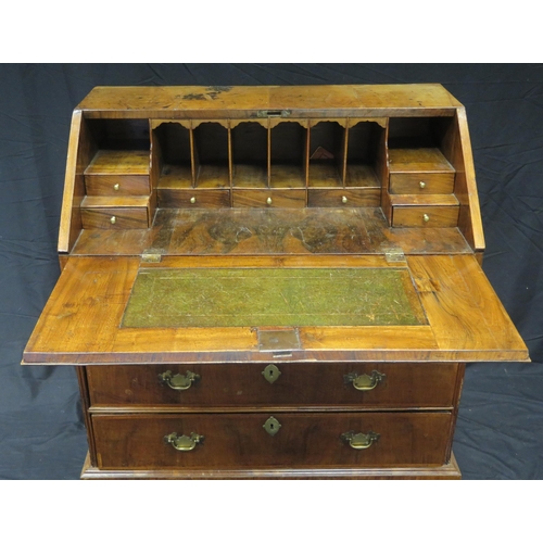 1592 - A George III walnut and feather banded bureau, the sloping hinged fall enclosing an arrangement of d... 