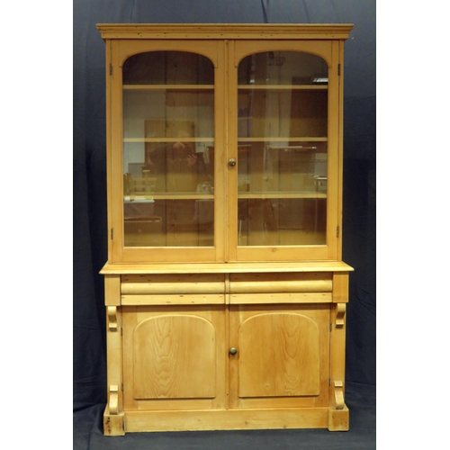 1601 - A Victorian stripped pine kitchen dresser, The upper part with a moulded cornice and a pair of arche... 