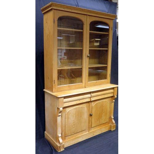 1601 - A Victorian stripped pine kitchen dresser, The upper part with a moulded cornice and a pair of arche... 