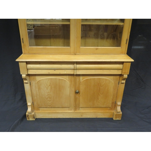 1601 - A Victorian stripped pine kitchen dresser, The upper part with a moulded cornice and a pair of arche... 