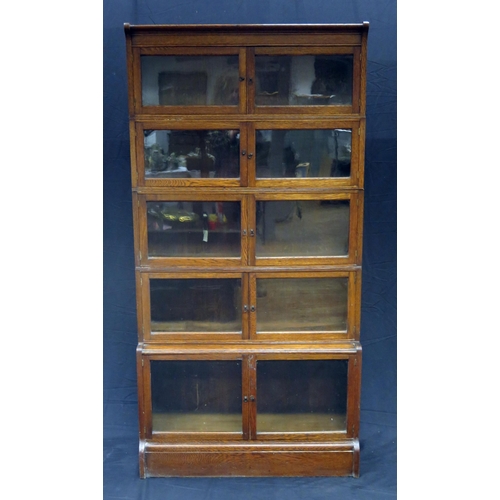 1603 - A Minty style oak five section bookcase, each section with  a pair of glazed panelled doors, on a pl... 