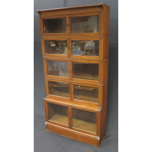 1603 - A Minty style oak five section bookcase, each section with  a pair of glazed panelled doors, on a pl... 