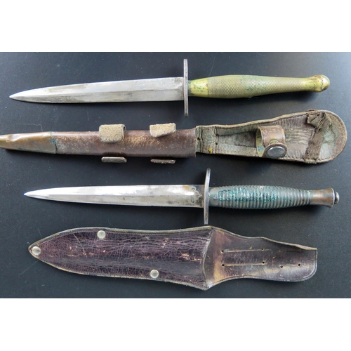 1465A - A Fairbairn-Sykes type commando knife, with 16cm double edged blade, with ribbed grip and button pom... 