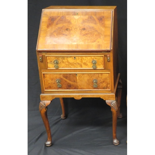 1597 - A reproduction walnut and crossbanded writing bureau, the sloping hinged fall enclosing a short draw... 