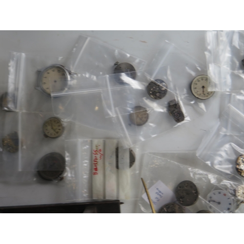 436 - A Selection of Watch Parts including eight new balance wheels and a 19th century clock