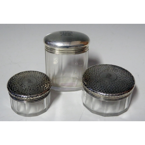 693 - A pair and single clear glass and silver mounted dressing table jars and covers, various makers and ... 