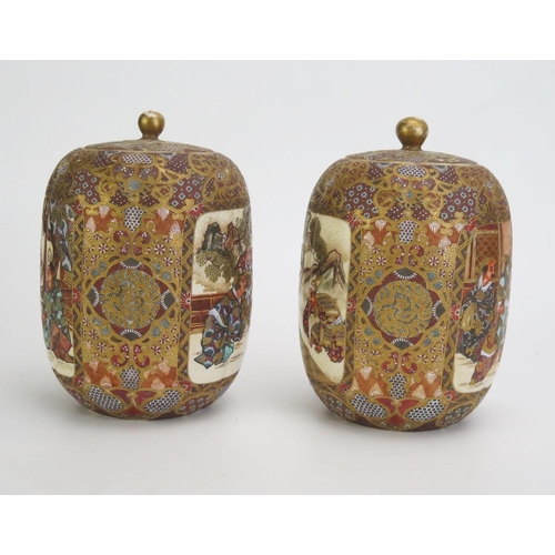 1330A - A pair of Japanese satsuma vases and covers, of cylindrical outline, decorated with panels depicting... 