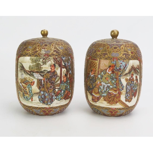 1330A - A pair of Japanese satsuma vases and covers, of cylindrical outline, decorated with panels depicting... 