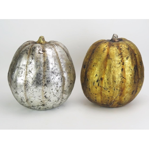 1366 - A gilded melon table centrepiece together with a matching silver coloured example, 31cm high.