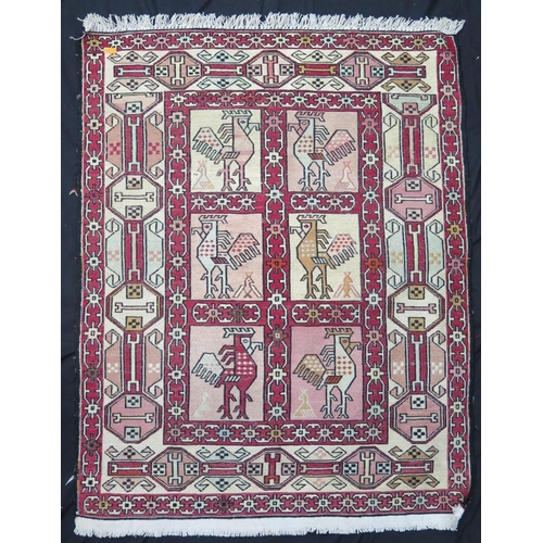 1568A - A Soumak flatweave rug, the wine red field with two rows of bird decorated medallions, enclosed by a... 