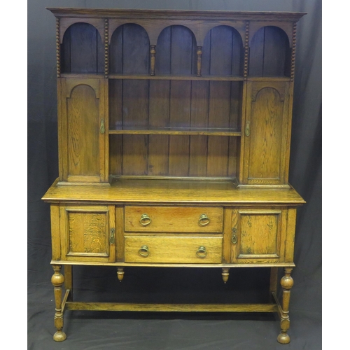 1619 - A reproduction oak dresser, the upper part with moulded cornice, and arrangement of shelves enclosed... 