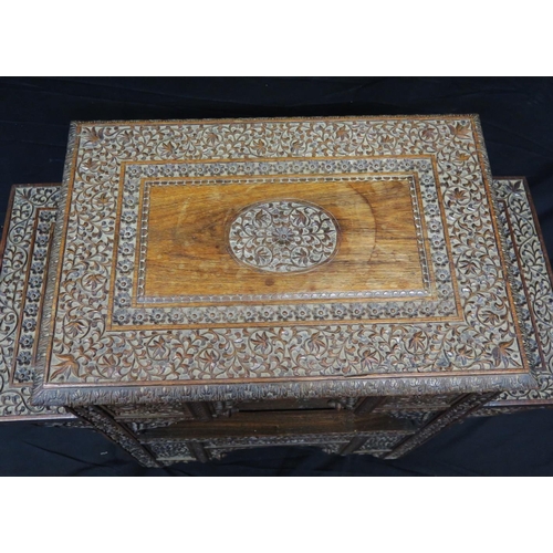 1623 - A Liberty style Moorish carved hardwood occasional table, the rectangular top with carved central me... 