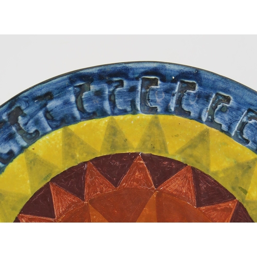 1004 - A Rare (possibly unique) and Early Troika Pottery Sun Plate or Wall Plaque decorated with blue, oran... 