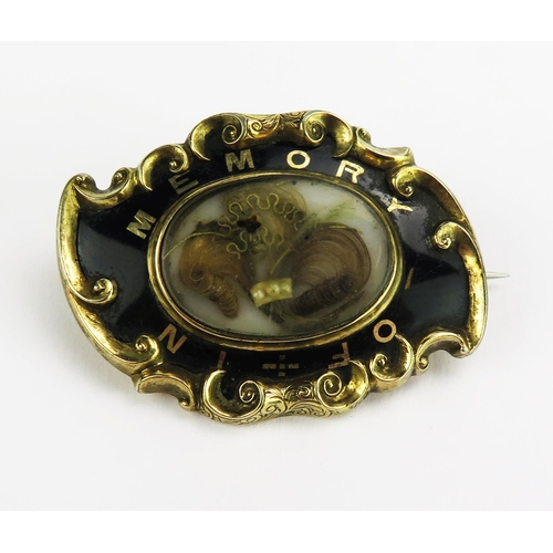 102 - A Victorian Yellow Metal and Enamel Memorial Brooch with a central glazed panel containing a lock of... 