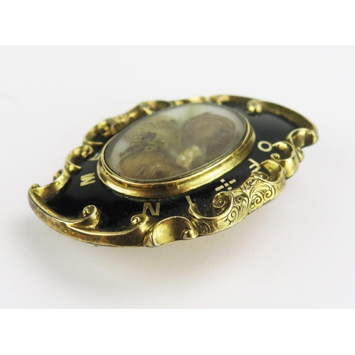 102 - A Victorian Yellow Metal and Enamel Memorial Brooch with a central glazed panel containing a lock of... 