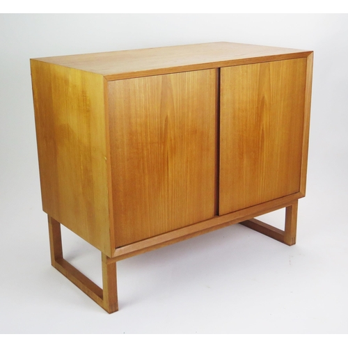 1052 - A 1960's Danish Teak Two Door Cabinet with single adjustable shelf, stamped MADE IN DENMARK, 80(l)x4... 