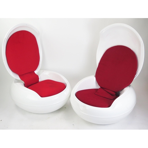 1074 - After a design by Peter Ghczy, a pair of fibreglass garden egg chairs, of squat ovoid form with hing... 