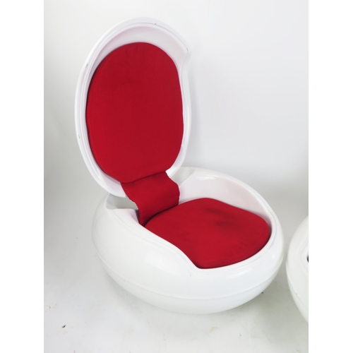 1074 - After a design by Peter Ghczy, a pair of fibreglass garden egg chairs, of squat ovoid form with hing... 