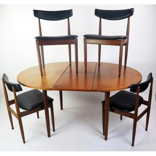 1076 - A 1970's G-Plan teak extending dining table with integral folding leaf, raised on turned legs, 150cm... 