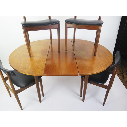 1076 - A 1970's G-Plan teak extending dining table with integral folding leaf, raised on turned legs, 150cm... 