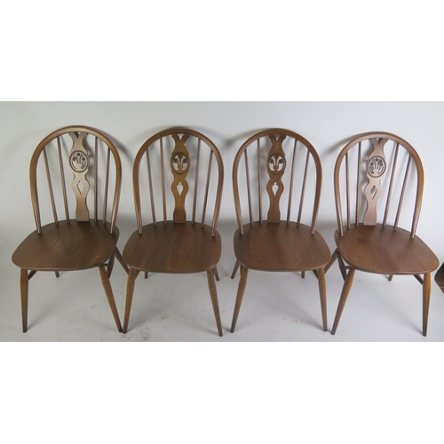 1086 - A set of four Ercol dining chairs, the oval backs with Prince of Wales feathers to the central splat... 