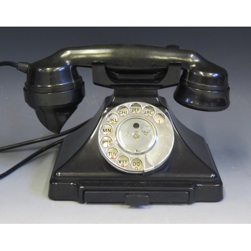 1094 - A GPO Model 1/232F telephone hand set in black Bakelite, with drawer to the base