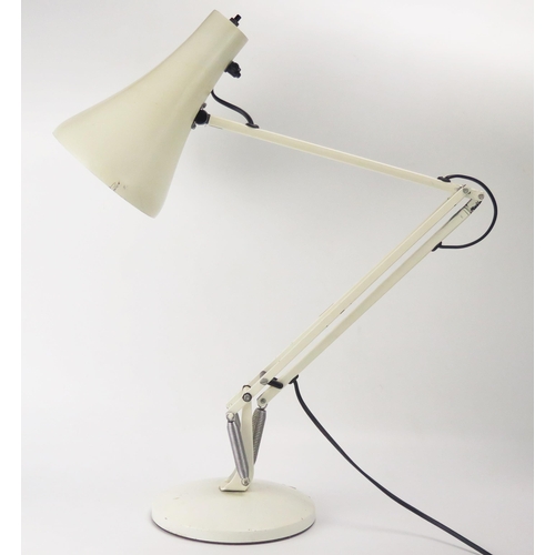 1103 - Herbert Terry, a 1970's model 90 angle-poise table lamp, in pale cream on a weighted circular base.