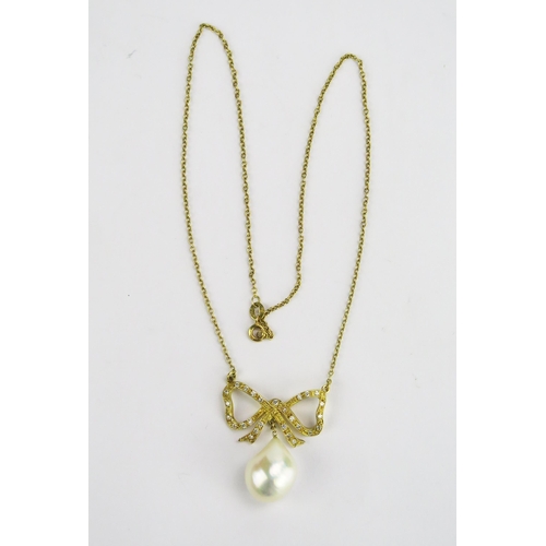 111 - An 18ct Gold, and Baroque Pearl or Cultured Pearl Necklace suspended beneath a diamond set bow and o... 