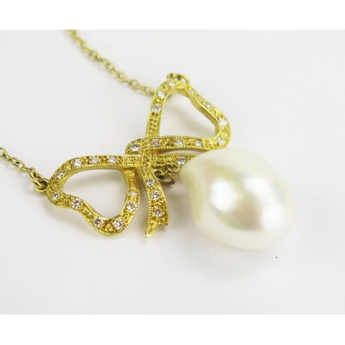 111 - An 18ct Gold, and Baroque Pearl or Cultured Pearl Necklace suspended beneath a diamond set bow and o... 