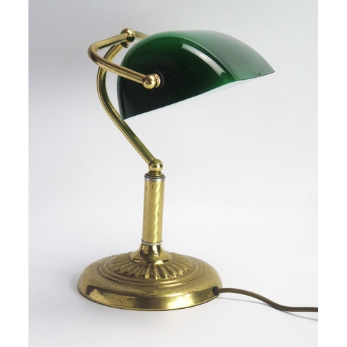 1111 - A lacquered brass banker's table lamp with green glass shade, on spiral twist column and weighted ci... 