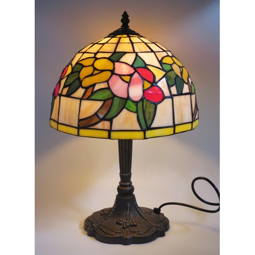 1113 - A Tiffany style table lamp, with leaded polychrome resin shade, on a fluted column and shaped dragon... 