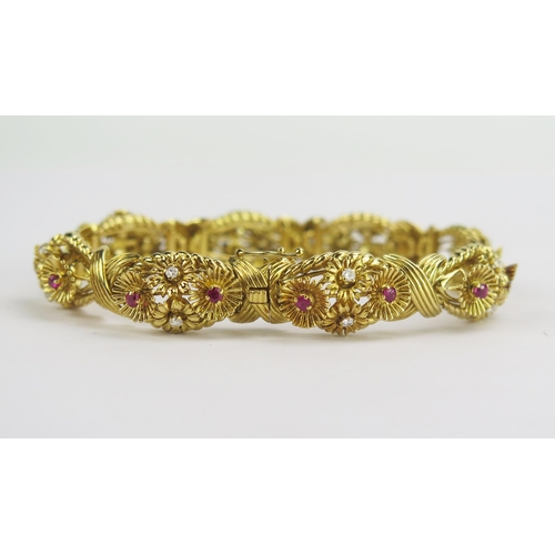 112 - A 1950's 18ct Gold, Ruby and Diamond Bracelet decorated with eight panels having stones in arranged ... 