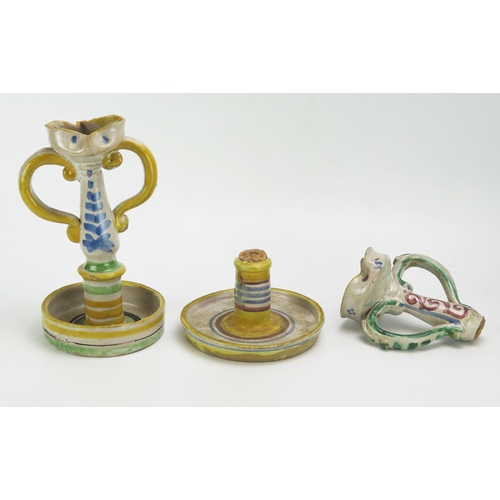 1131 - Two 18th century style Sicilian anthropomorphic majolica twin-handled candlesticks, with shaped nozz... 