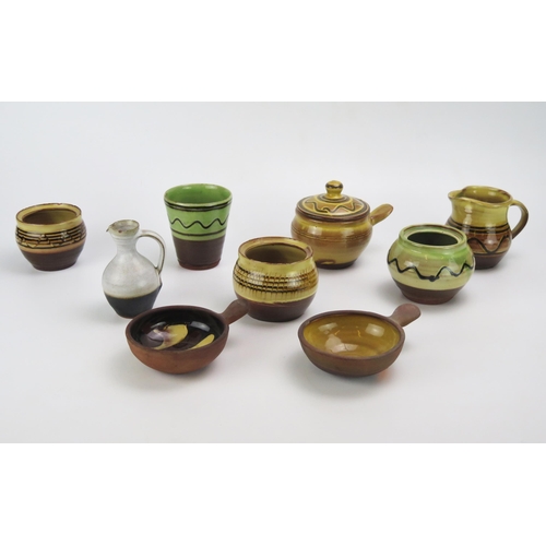 1136 - A collection of Winchcombe pottery slipware pots by S Tustin and C Tustin includes jugs, vases bowls... 