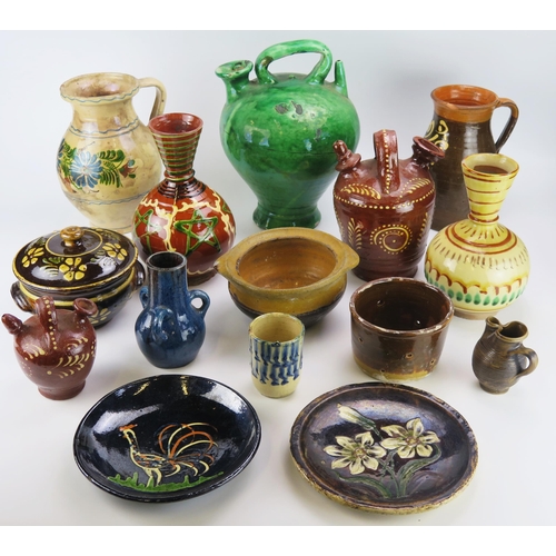 1141 - A collection of continental pottery wares mostly French, including wine ewers, vases, plates, bowls ... 